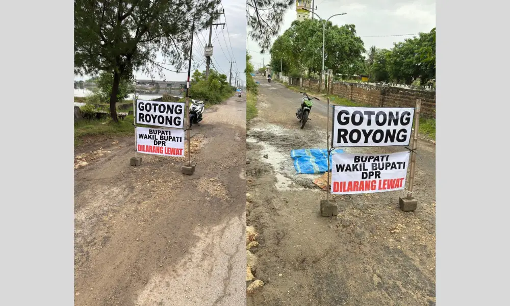 Spanduk protes warga bertuliskan "Gotong Royong" dan "Bupati Wakil Bupati DPR Dilarang Lewat" yang dipasang di tengah jalan rusak parah di Desa Karanganyar, Kecamatan Kalianget, Kabupaten Sumenep.